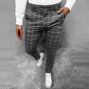 Close-up of slim fit men's plaid trousers in dark grey with fine grid pattern detail