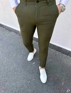 Detail view of men's slim fit plaid trousers in olive green paired with casual shoes
