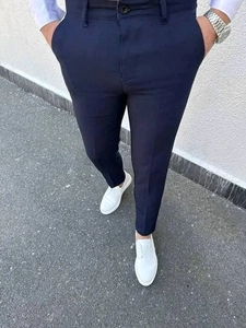 Detail of navy blue plaid suit pants for men featuring a slim fit and waist belt loops