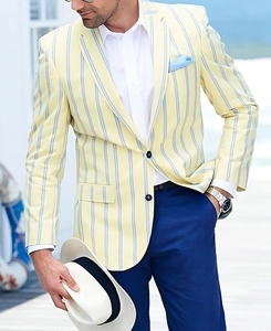 Detail of light yellow striped blazer with two-button closure and blue pocket square