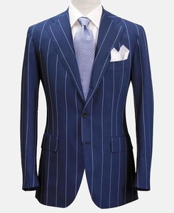 Close-up of navy blue pinstripe suit jacket with notched lapel and purple geometric tie