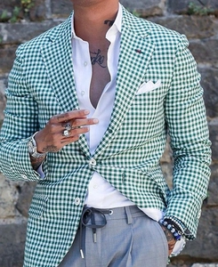 Detail shot of men's green and white checkered blazer with two-button closure and notch lapel
