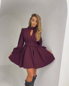 Detail view of the teardrop cutout neckline and long lantern sleeves on a burgundy dress