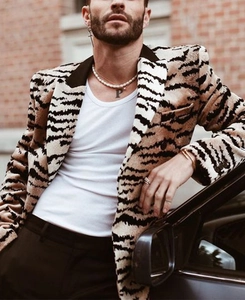 Detail of tiger print fuzzy blazer with pearl necklace and silver cross earring