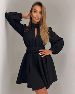 Detail of high neck cutout and puffed lantern sleeves on a black mini dress