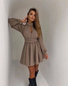 Detail view of mocha mini dress featuring teardrop cutout neckline and lantern sleeves