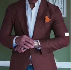 Detail of slim fit plaid blazer with notch lapel and orange pocket square for men