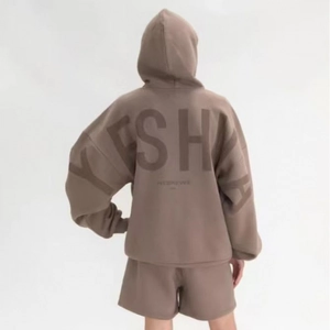 Detailed back view of a dark brown oversized hoodie with large YESHA foam letter printing
