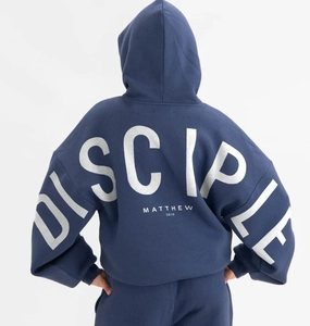 Detail of navy blue hoodie featuring white DISCIPLE print and Matthew 28:19 back graphic