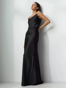 Close-up of elegant black satin maxi skirt featuring high-quality glossy fabric and cowl neck