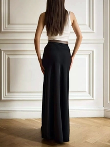 Rear view of elegant black high-waisted satin maxi skirt with a graceful fishtail silhouette