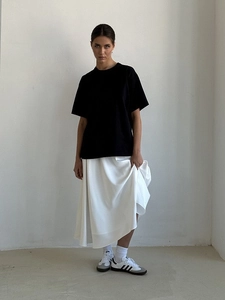 Detail view of the elegant heavy cotton black t-shirt and white flowing maxi skirt