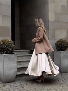 Elegant high-waist beige satin maxi skirt paired with an oversized camel blazer