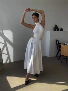 Elegant white halter top and satin maxi skirt set with side waist cut-out detail