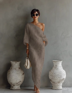 Detail of elegant brown knit maxi dress with one-shoulder design and puff sleeve