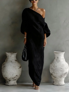 Elegant black one-shoulder pleated maxi dress with lantern sleeves and a minimalist silhouette