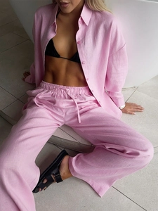 Detail view of pink linen blend shirt and high-waist drawstring trousers set