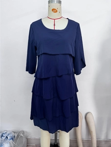 Dettaglio dell'abito in chiffon blu scuro con gonna a balze e design a strati sovrapposti