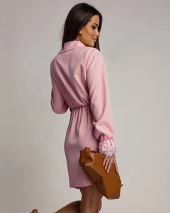 Detailed close-up of pink long-sleeve dress featuring delicate lace cuffs and elegant lapel