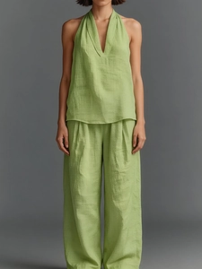 Detail of green sleeveless v-neck top and wide-leg trousers set with linen texture