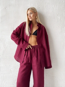 Close-up of wine red linen long sleeve shirt and matching wide leg trousers with drawstring