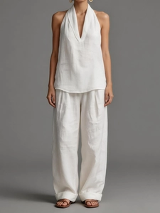 Detail of white sleeveless top and wide-leg trousers in textured breathable cotton linen