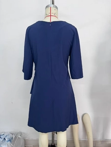 Vista posteriore di un abito blu navy a girocollo con cerniera invisibile e gonna a balze