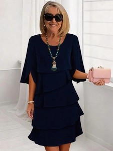 Elegante abito blu scuro a girocollo per donna con gonna a balze e pieghe