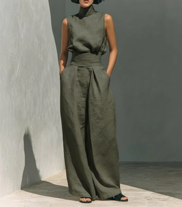 Detail of olive green sleeveless linen two-piece set featuring wide-leg trousers in outdoor light