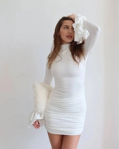 Detail of white slim fit mini dress with high collar and layered flare sleeves