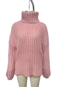 Detailed close-up of pink chunky knit texture and ribbed turtleneck design for women