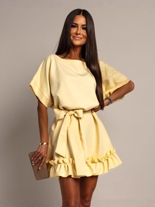 Elegant light yellow boat neck dress with a waist tie and ruffled hem details