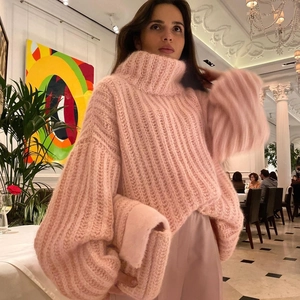 Pink chunky knit turtleneck sweater with puff sleeves and relaxed fit for winter wear