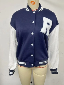 Detail of navy blue varsity jacket with white sleeves and letter R towel embroidery