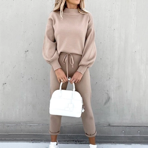 Detail of knit two-piece set featuring turtleneck lantern sleeves and drawstring waist pants