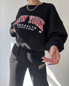 Detailed close-up of the New York printed pattern on black fleece hoodie set