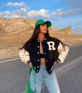 Detail of American retro baseball jacket with white R patch and contrast sleeves