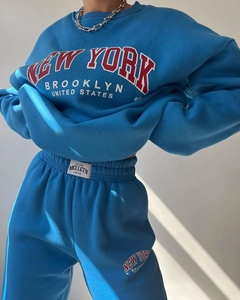 Detail of blue New York printed fleece sweatshirt set with ribbed cuffs and soft cotton texture