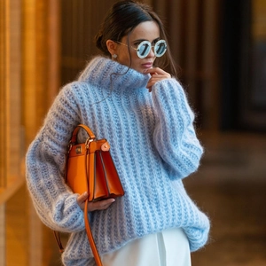 Detail of light blue oversized turtleneck sweater showing thick knit mohair texture
