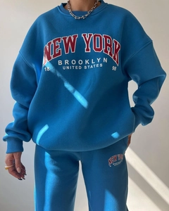 Detail of blue fleece tracksuit with New York Brooklyn print and drop shoulder design