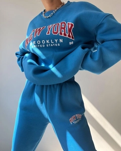Detail of blue fleece tracksuit featuring New York embroidery and high-quality cotton fabric