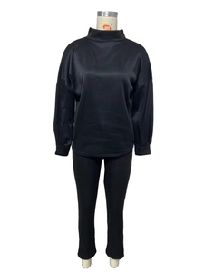 Front view of black two-piece casual set featuring high neck top and slim trousers