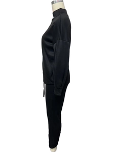 Side view of black fleece tracksuit featuring high neck sweatshirt and jogger pants