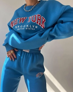 Close-up of royal blue tracksuit featuring New York graphic print and premium cotton fabric