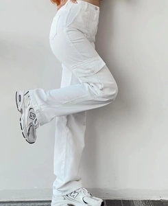 Detail view of white high-waisted cargo pants with side flap pockets and twill fabric