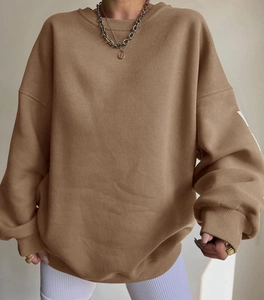 Close-up of brown oversized sweatshirt featuring ribbed cuffs and drop shoulder seam details