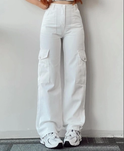 Detail view of white high-waisted cargo pants with side flap pockets and wide leg cut