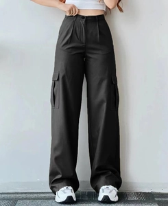 Detail of black wide-leg cargo pants featuring large utility pockets and high-waist design