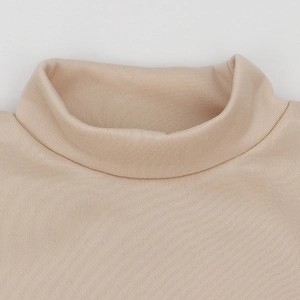Detailed view of the ribbed turtleneck collar on a beige fleece knit sweatshirt