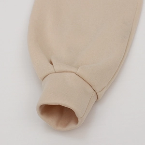 Detail of ribbed cuffs on beige long sleeve tracksuit with high-density cotton fleece texture